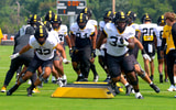 Marquis Gracial (33) and Daeden Hopkins (93) lead a line in warmups