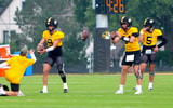 Beau Pribula (9) and Sam Horn (21) catch snaps during a drill while Matt Zollers (5) looks on