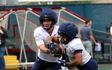 West Virginia quarterback Nicco Marchiol handsoffs to running back Jahiem White during fall practice