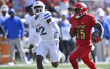 Oct 5, 2024; Louisville, Kentucky, USA; Louisville Cardinals running back Isaac Brown (25) runs the ball against Southern Methodist Mustangs safety Cale Sanders Jr. (22) during the second half at L&N Federal Credit Union Stadium. Mandatory Credit: Jamie Rhodes-Imagn Images