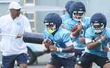 UNC receivers coach Garrick McGee with Alex Taylor and Jordan Shipp.