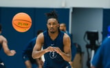 West Virginia guard Chance Moore bringing in the pass at practice