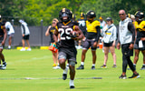 Ahmad Hardy runs through a read drill with RB coach Curtis Luper (back right) talking to him