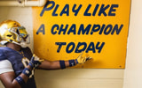 Elijah Golden with Notre Dame's Play Like A Champion Today sign.