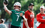 U of L QB Miller Moss (7) passes during practice as OC Brian Brohm and head coach Jeff Brohm, right, watch on the practice field at Cardinal Stadium in Louisville, Ky. on July 30, 2025.