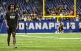 Tony Brown walks with staff ahead of game
