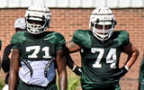 From left, Michigan State's Rustin Young, Kristian Phillips, and Gavin Broscious listen to coaches during football practice on Monday, Aug. 11, 2025, in East Lansing. - Nick King, USA TODAY Sports
