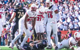 Louisville football's A.J. Green (98) and Antonio Watts (35) celebrate a tackle for loss in the 35-34 2025 Sun Bowl win over Washington.