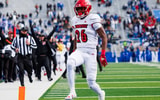 Nov 30, 2024; Lexington, Kentucky, USA; Louisville Cardinals running back Duke Watson (26) carries the ball into the end zone for a touchdown during the third quarter against the Kentucky Wildcats at Kroger Field. Mandatory Credit: Jordan Prather-Imagn Images