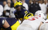 Aug 30, 2025; Ann Arbor, Michigan, USA;  Michigan Wolverines quarterback Bryce Underwood (19) gets set to run a play in the first half against the New Mexico Lobos at Michigan Stadium. Mandatory Credit: Rick Osentoski-Imagn Images