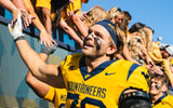 West Virginia linebacker Chase Wilson celebratest the win over Robert Morris