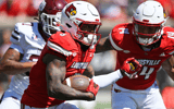 Aug 30, 2025; Louisville, Kentucky, USA; Louisville Cardinals wide receiver Caullin Lacy (5) runs the ball against Eastern Kentucky Colonels linebacker Blake Howard (37) during the first quarter at L&N Federal Credit Union Stadium. Mandatory Credit: Jamie Rhodes-Imagn Images