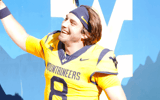 West Virginia quarterback Nicco Marchiol with fans after the Robert Morris win