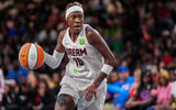 Aug 27, 2025; College Park, Georgia, USA; Atlanta Dream guard Rhyne Howard (10) controls the ball against the Las Vegas Aces during the second half at Gateway Center Arena at College Park. Mandatory Credit: Dale Zanine-Imagn Images
