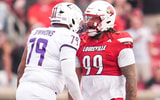 Louisville Cardinals defensive lineman Jordan Guerad (99) has words with James Madison Dukes offensive lineman Joseph Simmons (79) in the first half during the Louisville-James Madison college football game Friday September 5, 2025 at L&N Credit Union Stadium in Louisville, Kentucky.