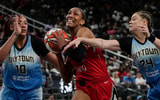 Las Vegas Aces center A'ja Wilson (22) drives the ball between Chicago Sky center Kamilla Cardoso (10) and guard Rachel Banham (24) during the second half of a WNBA basketball game at T-Mobile Arena. Mandatory Credit: Lucas Peltier-Imagn Images