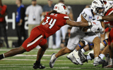 Sep 5, 2025; Louisville, Kentucky, USA; James Madison Dukes running back Jordan Fuller (23) runs the ball against Louisville Cardinals linebacker TJ Quinn (34) during the second half at L&N Federal Credit Union Stadium. Mandatory Credit: Jamie Rhodes-Imagn Images
