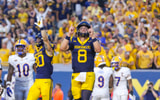 West Virginia quarterback Nicco Marchiol celebrates the touchdown against Pitt