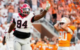Brianna Paciorka/News Sentinel / USA TODAY NETWORK via Imagn Images | Tennessee place kicker Max Gilbert (90) holds his helmet in disbelief as Georgia defensive lineman Xzavier McLeod (94) celebrates Gilbert's missed field goal in the final seconds of a college football game between Tennessee and Georgia at Neyland Stadium in Knoxville, Tenn., on Sept. 13, 2025.
