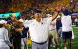 West Virginia offensive line coach Jack Bicknell celebrates the Pitt win