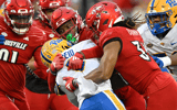 Nov 23, 2024; Louisville, Kentucky, USA; Louisville Cardinals linebacker Stanquan Clark (6) and linebacker TJ Quinn (34) tackle Pittsburgh Panthers running back Desmond Reid (0) during the first half at L&N Federal Credit Union Stadium. Mandatory Credit: Jamie Rhodes-Imagn Images