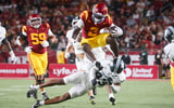USC running back Waymond Jordan leaps a Michigan State defender