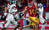 USC Trojans quarterback Jayden Maiava (14) runs the ball against Michigan State Spartans defensive back Malik Spencer (43) during the second half at the Los Angeles Memorial Coliseum