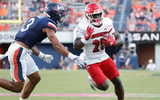 Oct 12, 2024; Charlottesville, Virginia, USA; Louisville Cardinals running back Isaac Brown (25) carries the ball past Virginia Cavaliers safety Corey Thomas Jr. (3) to score a touchdown during the second half at Scott Stadium. Mandatory Credit: Amber Searls-Imagn Images