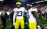 Sep 6, 2025; Norman, Oklahoma, USA; Michigan Wolverines linebacker Ernest Hausmann (15) and linebacker Cole Sullivan (23) resct after the game against the Oklahoma Sooners at Gaylord Family-Oklahoma Memorial Stadium. Mandatory Credit: Kevin Jairaj-Imagn Images