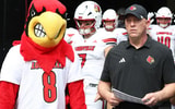 Sep 27, 2025; Pittsburgh, Pennsylvania, USA; Louisville Cardinals head coach Jeff Brohm (right) leads the team onto the field to play the Pittsburgh Panthers at Acrisure Stadium. Mandatory Credit: Charles LeClaire-Imagn Images