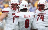 Sep 27, 2025; Pittsburgh, Pennsylvania, USA; Louisville Cardinals wide receiver Chris Bell (0) celebrates his touchdown with tight end Nate Kurisky (85) and offensive lineman Jordan Church (74) against the Pittsburgh Panthers during the second quarter at Acrisure Stadium. Mandatory Credit: Charles LeClaire-Imagn Images