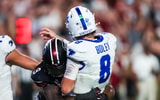 Sep 27, 2025; Columbia, South Carolina, USA; South Carolina Gamecocks linebacker Desmond Umeozulu (9) hits Kentucky Wildcats quarterback Cutter Boley (8) as he passes which causes an interception in the second quarter at Williams-Brice Stadium. Mandatory Credit: Jeff Blake-Imagn Images