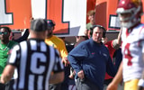 Illinois Fighting Illini head coach Bret Bielema looks on as USC Trojans quarterback Jayden Maiava (14) talks with an official during the first half at Memorial Stadium