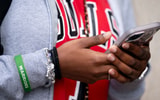 A Tennessee student uses a cell phone before putting it in a Yondr pouch during the school day, via Denny Simmons : The Tennessean : USA TODAY NETWORK via Imagn Images