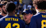 Michigan tight ends coach Steve Casula talks to players in a huddle during warm up ahead of the New Mexico game at Michigan Stadium in Ann Arbor on Saturday, August 30, 2025. © Junfu Han / USA TODAY NETWORK via Imagn Images
