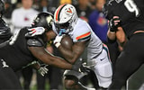 Nov 9, 2023; Louisville, Kentucky, USA; Virginia Cavaliers running back Kobe Pace (5) runs the ball against Louisville Cardinals defensive lineman Dezmond Tell (99) during the second half at L&N Federal Credit Union Stadium. Louisville defeated Virginia 31-24. Mandatory Credit: Jamie Rhodes-Imagn Images