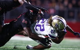 Washington running back Cameron Davis is tackled by Rutgers linebacker Dariel Djabome