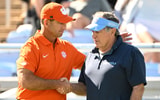 UNC coach Bill Belichick and Clemson coach Dabo Swinney meet in the pregame on Saturday.