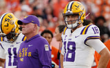 Aug 30, 2025; Clemson, South Carolina, USA; LSU Tigers head coach Brian Kelly and quarterback Garrett Nussmeier (18) look on during warmups before the game against the Clemson Tigers at Memorial Stadium.