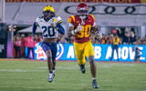 USC running back King Miller runs away from a Michigan defender