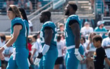 Jacksonville Jaguars Jacksonville Jaguars punter Logan Cooke (9), Jacksonville Jaguars quarterback Trevor Lawrence (16), Jacksonville Jaguars linebacker Foye Oluokun (23) and defensive end Josh Hines-Allen walks with his son Wesley, 8, right, a cancer survivor, in tow as they walk on the field. Wesley was the honorary captain for Sunday’s game against the Seattle Seahawks in an NFL football game at EverBank Stadium, Sunday, Oct. 12, 2025, in Jacksonville, Fla. [Doug Engle/Florida Times-Union]