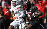 Oct 19, 2024; Louisville, Kentucky, USA; Louisville Cardinals wide receiver Chris Bell (0) runs the ball against the Miami Hurricanes during the first half at L&N Federal Credit Union Stadium. Mandatory Credit: Jamie Rhodes-Imagn Images