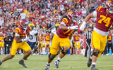 USC running back King Miller carries the ball behind offensive linemen Justin Tauanuu and Alani Noa