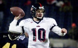 Ole Miss backup quarterback Eli Manning (10) throws a pass under pressure to spark an unsuccessful comeback bid against West Virginia in the Music City Bowl game at Adelphia Coliseum Dec. 28, 2000. West Virginia retiring head coach Don Nehlen won his last game with a 49-38 victory. (© George Walker IV / The Tennessean via Imagn Content Services, LLC_)