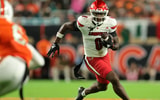 Oct 17, 2025; Miami Gardens, Florida, USA; Louisville Cardinals wide receiver Chris Bell (0) carries the football against the Miami Hurricanes during the first quarter at Hard Rock Stadium. Mandatory Credit: Sam Navarro-Imagn Images