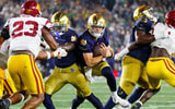 Notre Dame quarterback CJ Carr, center, runs with the ball in the second half of a NCAA football game against USC at Notre Dame Stadium on Saturday, Oct. 18, 2025, in South Bend