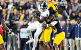 Michigan State wide receiver Nick Marsh (6) makes a catch against Michigan defensive backs Jyaire Hill (20) and Quinten Johnson (28) during the first half at Michigan Stadium in Ann Arbor. - Junfu Han, USA TODAY Sports