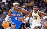 Oct 23, 2025; Indianapolis, Indiana, USA; Oklahoma City Thunder guard Shai Gilgeous-Alexander (2) dribbles the ball while Indiana Pacers guard Bennedict Mathurin (00) defends in the second half at Gainbridge Fieldhouse. Mandatory Credit: Trevor Ruszkowski-Imagn Images