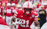 Nebraska football running back Emmett Johnson (21) runs the ball against the Northwestern Wildcats during the first quarter at Memorial Stadium.