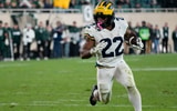 Oct 25, 2025; East Lansing, Michigan, USA; Michigan Wolverines running back Justice Haynes (22) carries the ball for a touchdown against the Michigan State Spartans during the second half at Spartan Stadium. Mandatory Credit: Brendan Mullin-Imagn Images